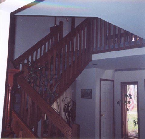 Front door is on the right, just outside the photo. Stairs and upper hallway 