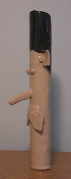 Photo: Side view of a ceramic tube made to look like a man's neck and head.