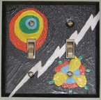 Photo: Painted switchplate of a stylized sun, lightning bolt, and flower, by Cathy Williams Carroll.