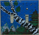 Photo: Painted switchplate of a birch tree trunk and pine trees by Kevin Brown.