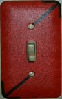 Photo: Painted switchplate of abstract arrows pointing upstairs and downstairs, by Mark Silver.