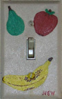 Photo: Painted switchplate of a green pear, a strawberry, and a banana, by Nancy Williams.