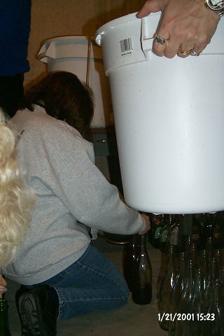 A fresh bucket waiting to be brought in, while a bottle is filled with the last of the prior bucket.