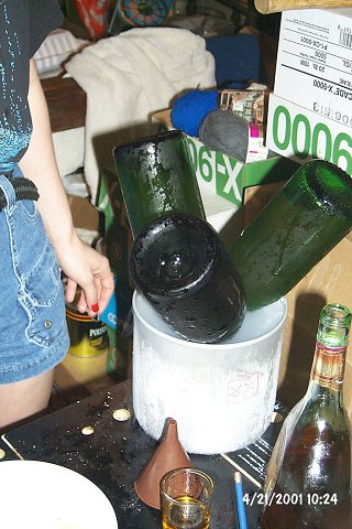 Bottle necks being frozen before the yeast remnant plugs are removed.