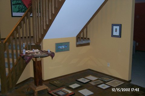 Zeke Towne, wooden table with secret drawers.  Various woods (oak, black walnut, maple), with beveled glass top.
Unknown artist, watercolor of a turtle on a log.  Painted by an intern at one of the Junction Annual Kitemakers Retreat.
Daryl V. Storrs, "Lizard", print of a neon lizard.