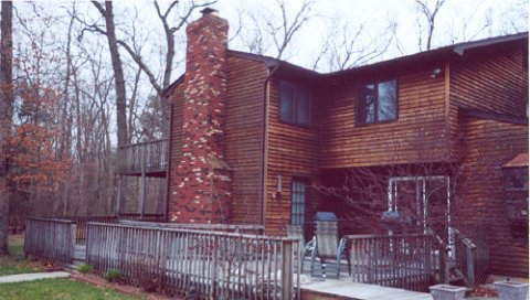 The deck wraps around to the south side of the house (left side in the photo). Chimney's attached to the family room.