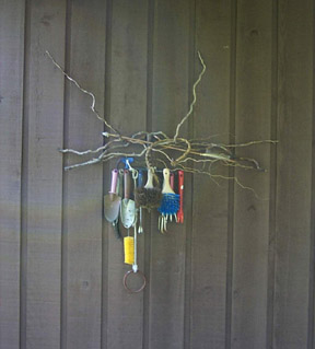 Photo: Garden hand tools on a wood siding wall, arranged by Cathy Williams Carroll