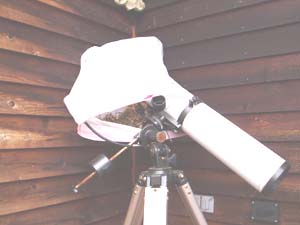 A telescope wrapped in plastic with a hint of a nest inside.